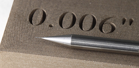 Photo showing the detail achievable using Mantle’s sinter-based metal Additive Manufacturing technology for tooling, with a 0.005” endmill for scale (Courtesy Mantle)  