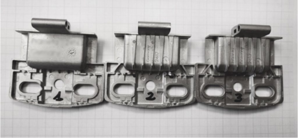 Fig. 3 Design evolution (left to right) of the smaller MIM hinge. The biggest change is seen on the second sample (first iteration), while the final iteration was changed only to solve small defects and improve the safety margin of fatigue results