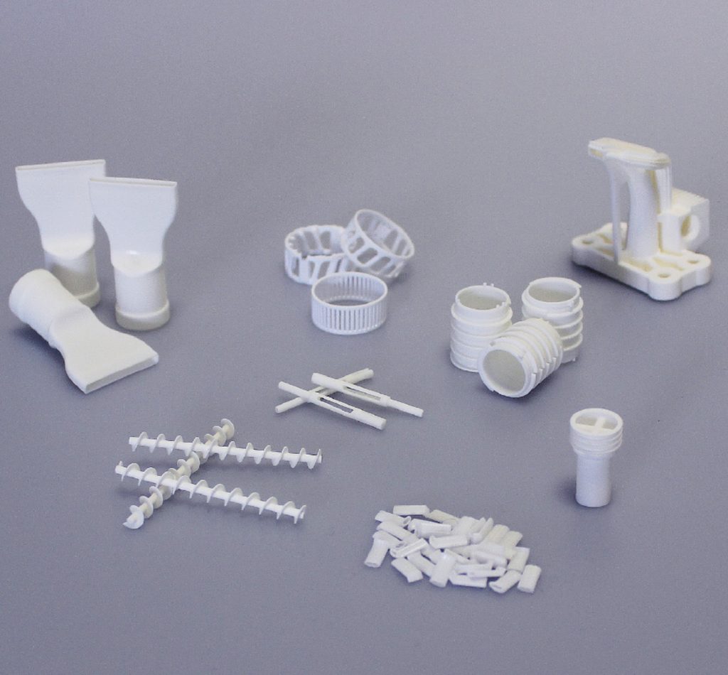 Fig. 7 The tubes featured in this article, together with other ceramic parts, additively manufactured in series by Steinbach (Courtesy Steinbach AG)