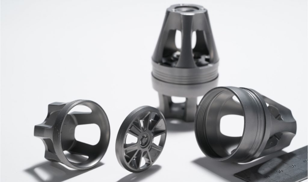 Fig. 8 An upper cap, lower cap, split centre, and split centre bleed for a high-end automotive suspension system (Courtesy MPIF)