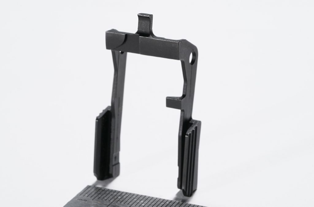 Fig. 10 A one-piece slide release for a firearm (Courtesy MPIF)