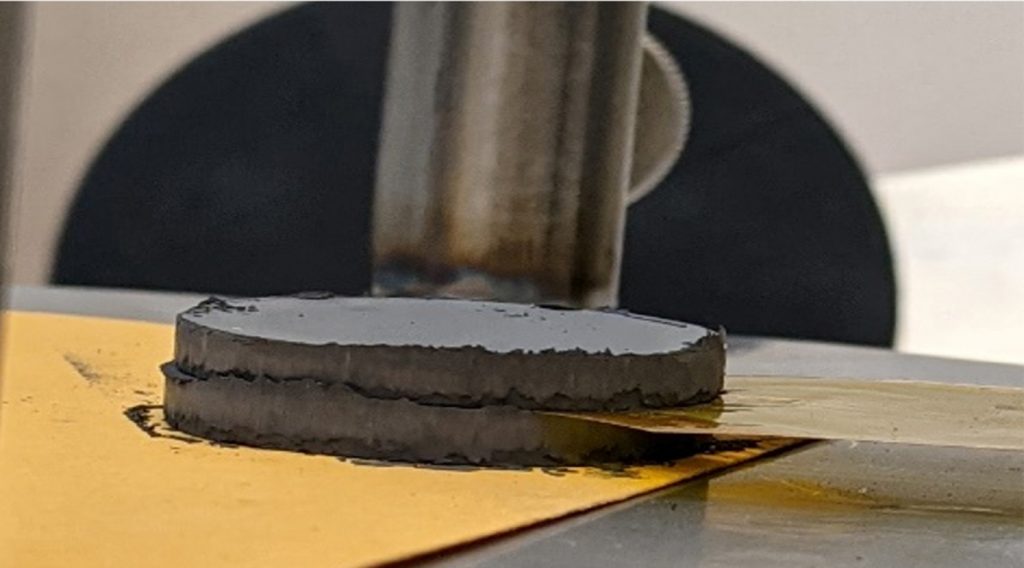 Fig. 10 Measurement set up using two pressed green compacted metal powder pellets, with the hot disc sensor between them (Courtesy Orton Ceramics)