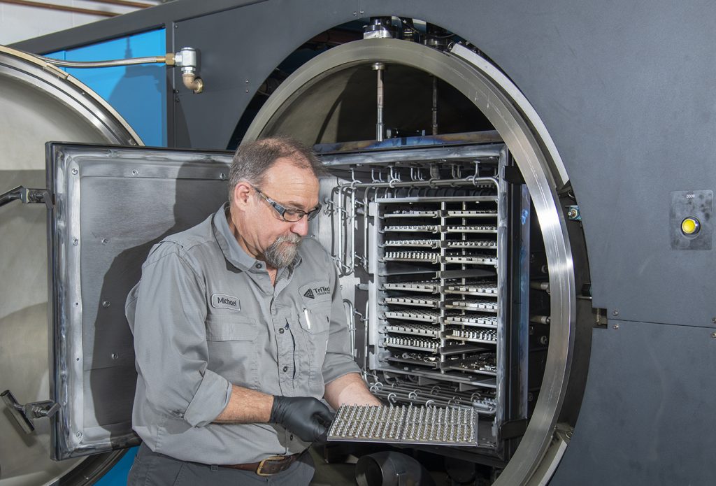 Fig. 3 A tray of sintered titanium parts being removed from an Elnik Systems vacuum sintering furnace (Courtesy TriTech Titanium Parts)