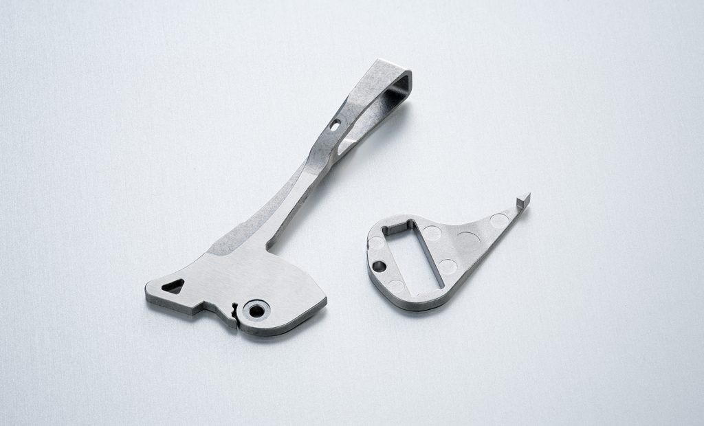 Fig. 9 These inserts are critical control components in vessel sealing instruments. The part is overmoulded with thermoplastic and serves as a lever for actuating the vessel seal. This insert is made from 17-4 PH stainless steel (Courtesy Parmaco)
