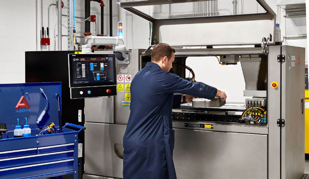 Fig. 2 Mattia Forgiarini preparing one of Azoth’s Digital Metal (now Markforged) Binder Jet machines (Courtesy Azoth)