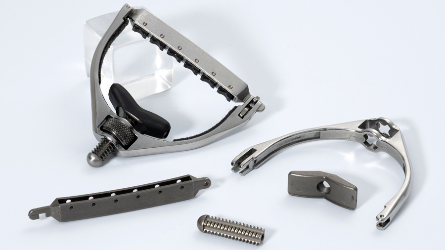 Six-string guitar capo assembly, produced via MIM and AM by APG-MIM (Courtesy MPIF)