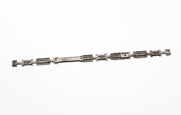 Middle plate used in the hinge of a folding mobile phone (Courtesy MPIF)