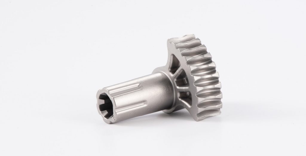 Fig. 5 This worm gear, used in an automotive transmission locking mechanism, won an MPIF Design Excellence Award in 2021. MIM was chosen for its ability to produce the complex helical gear teeth and adjacent shaft geometry. Custom setters are used for sintering the parts, which require no secondary operations to function in the mating assembly (Courtesy MPIF)