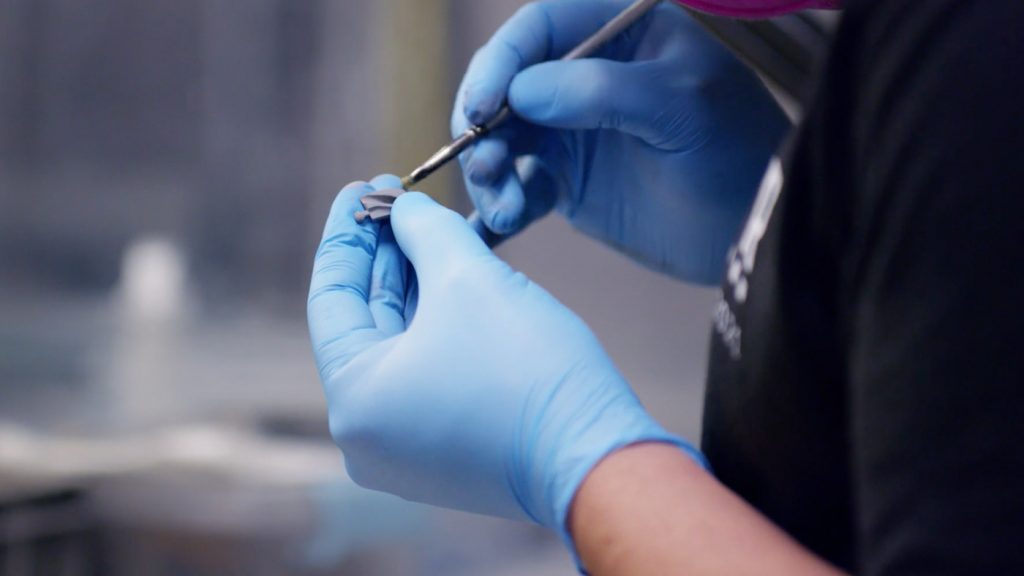 Fig. 8 The final cleaning of a green part before placing it on a sintering tray (Courtesy 3DEO)