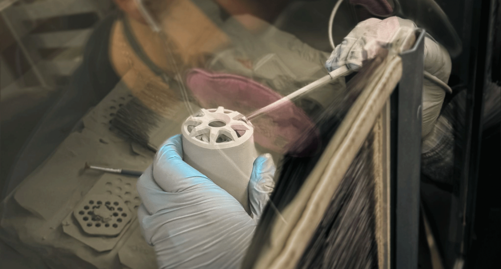 Fig. 3 Depowdering of BJT parts at FreeFORM Technologies (Courtesy FreeFORM Technologies)