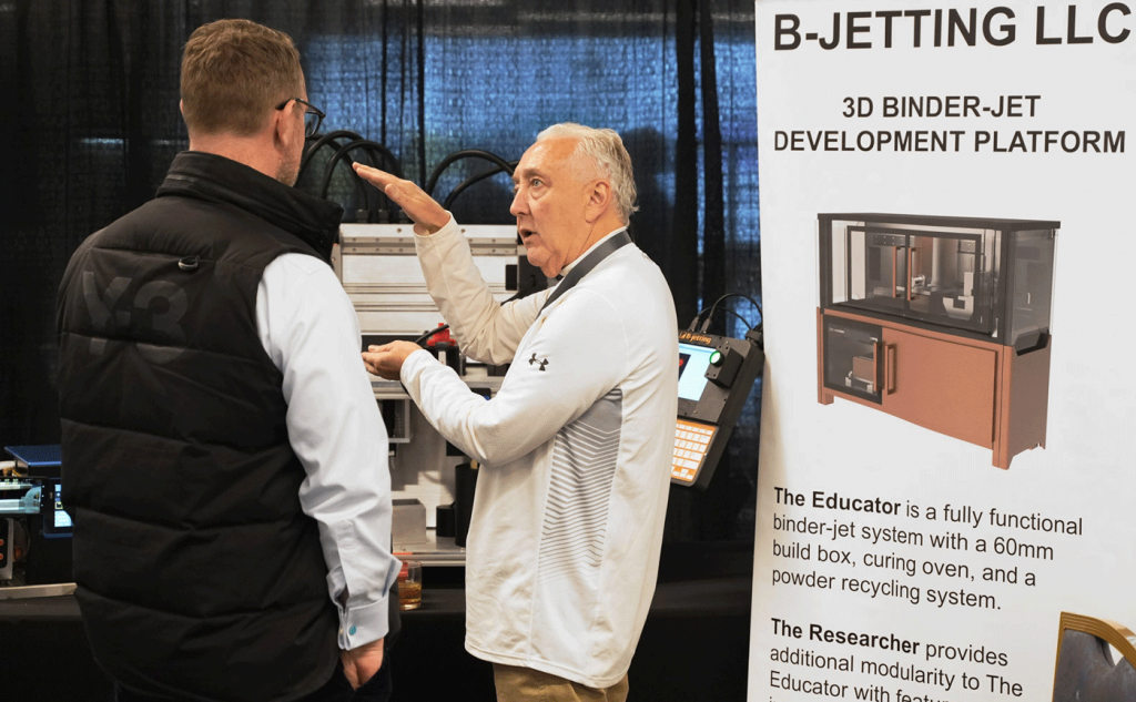 Fig. 8 James Gill, co-founder and Managing Partner of B-jetting LLC, introducing the company’s Educator machine at AMUG2025
