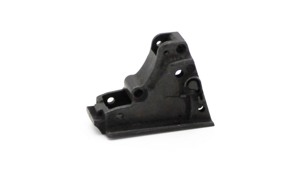 Fig. 10 Advanced Powder Products: sear housing block with precision holes for pistol (Courtesy MPIF)