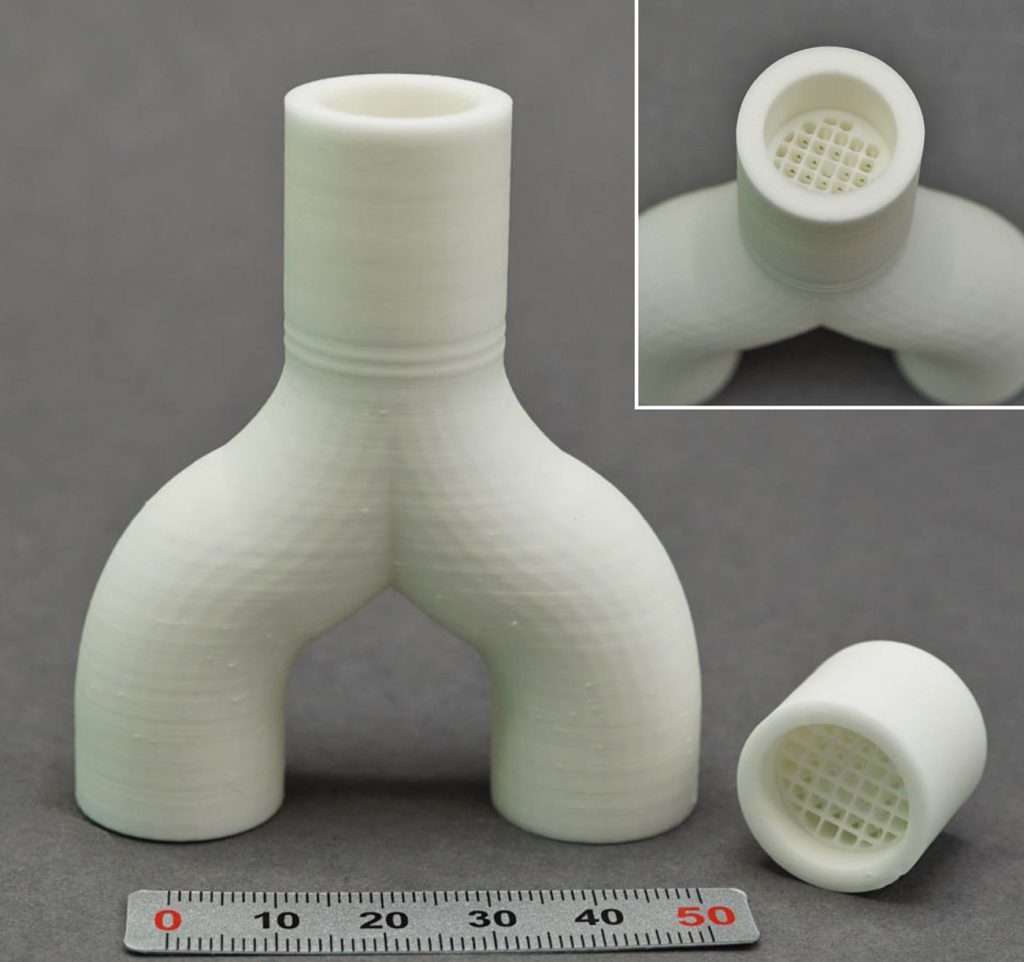 Fig. 10 AM alumina components with the tubing made by FFF (green machined inner wall) and the mixer made by VPP, sinter joined (Courtesy Fraunhofer IKTS)