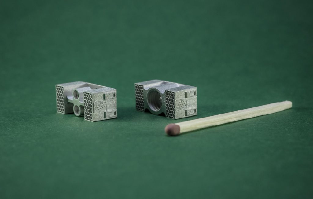 Fig. 13 Small, high-precision metal components produced using Lithography-based Metal Manufacturing (LMM), showing the fine features achievable (Courtesy MetShape)