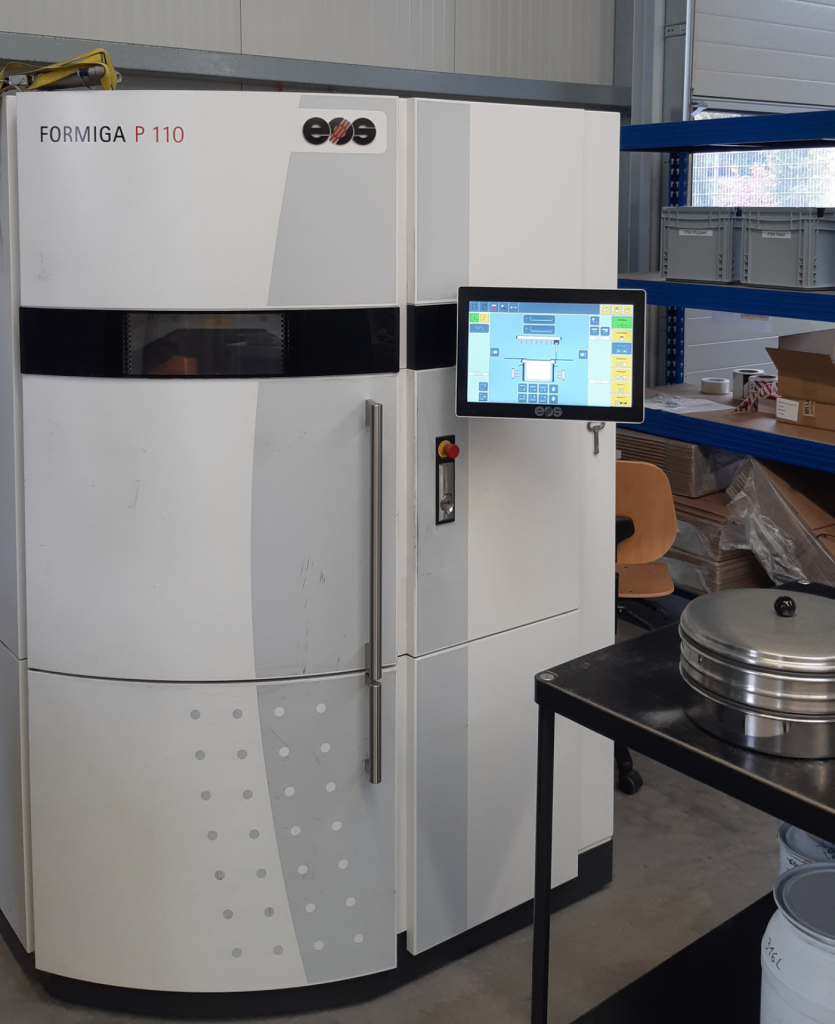 Fig. 13 An EOS Formiga P110 Laser Beam Powder Bed Fusion machine used for additively manufacturing green parts from CMF feedstock
