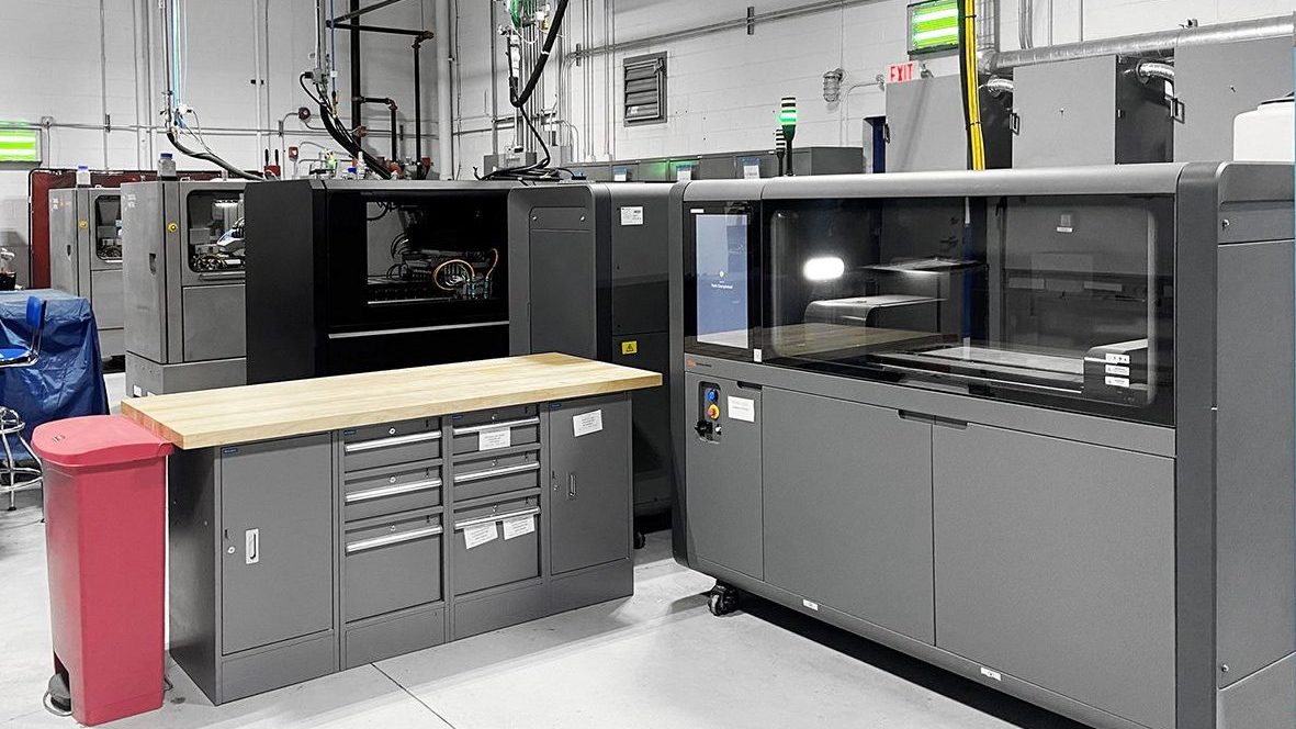 Fig. 6 Binder Jetting machines installed at Azoth. A Desktop Metal machine is in the foreground, and Markforged machines are at the rear (Courtesy Azoth)