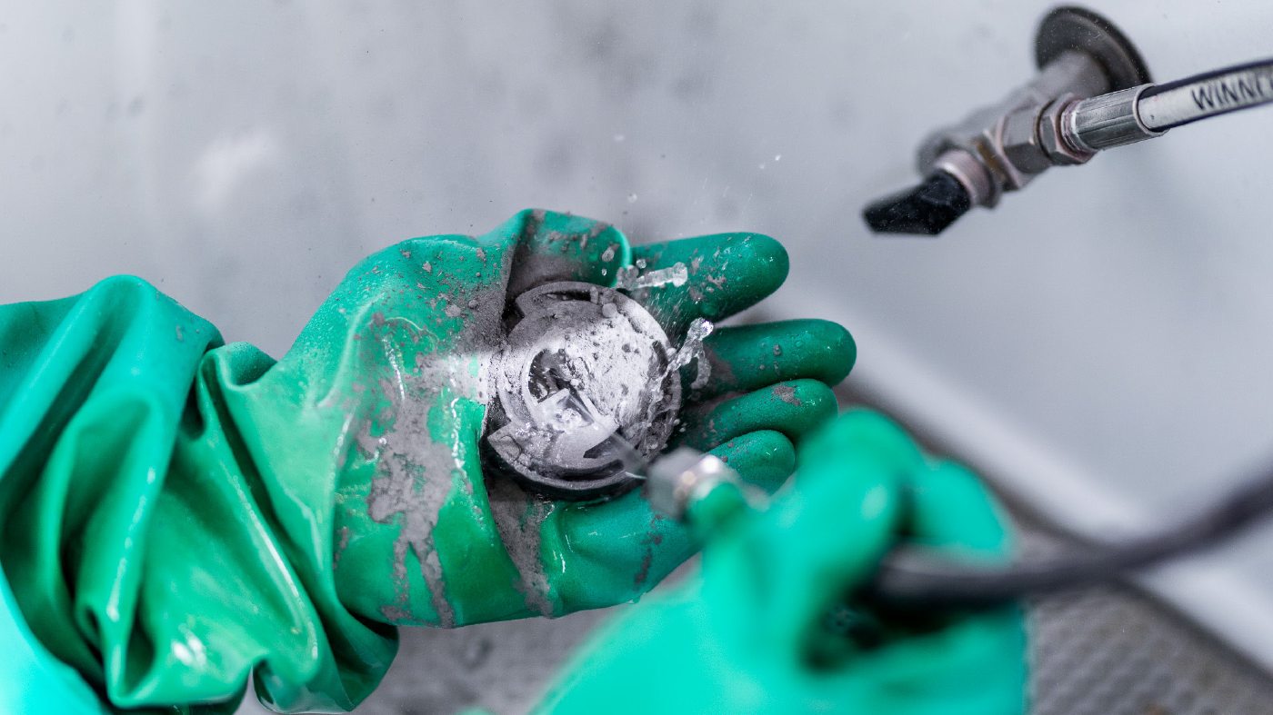Fig. 6 Depowdering of a CMF green part with water