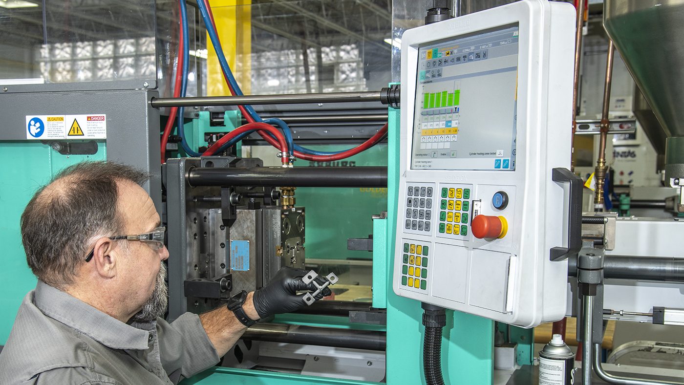 Fig. 4 Parts being removed from an Arburg Allrounder injection moulding machine (Courtesy TriTech Titanium Parts)