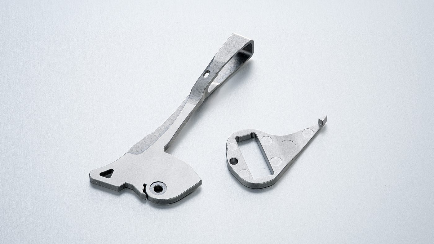 Fig. 9 These inserts are critical control components in vessel sealing instruments. The part is overmoulded with thermoplastic and serves as a lever for actuating the vessel seal. This insert is made from 17-4 PH stainless steel (Courtesy Parmaco)
