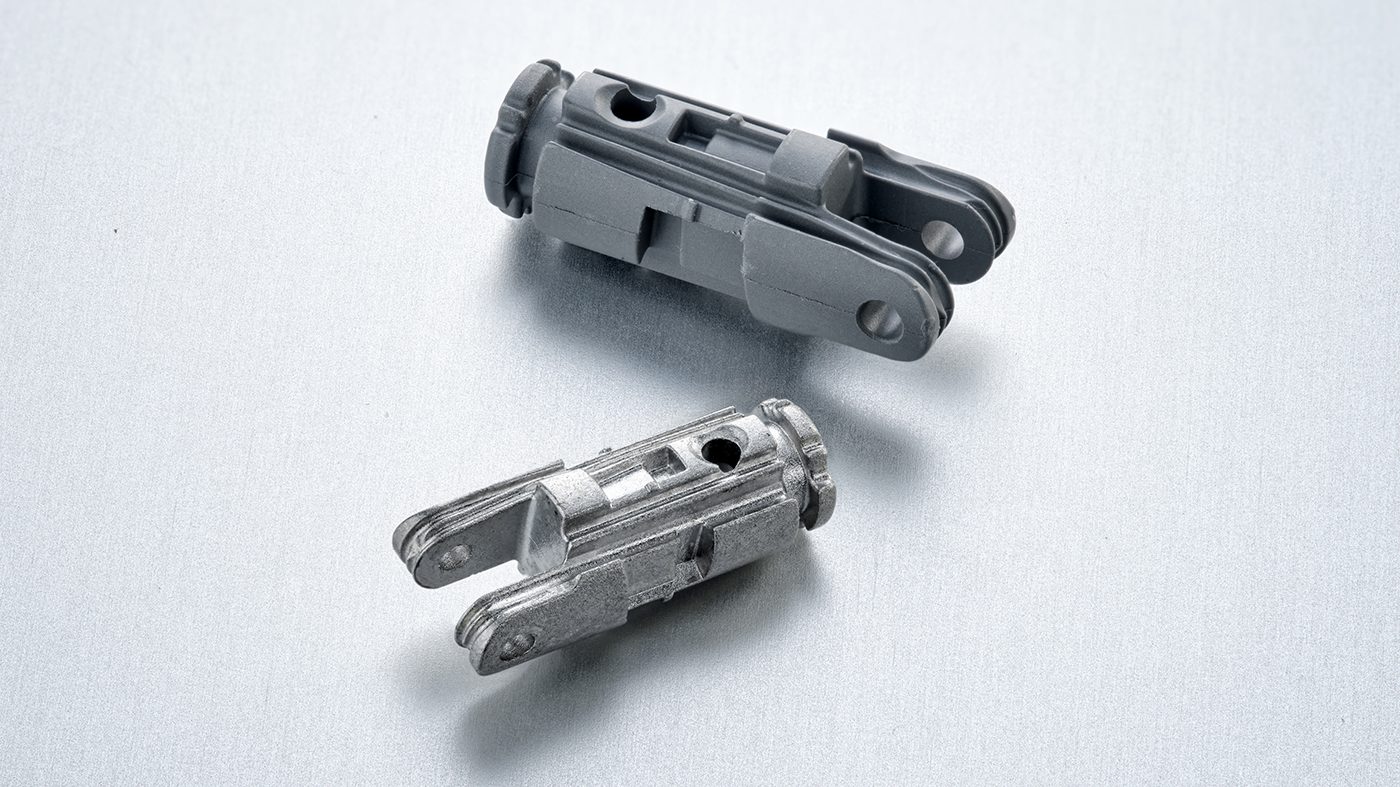 Fig. 11 This fork is an articulation part used in the instrument control system of a robot-assisted surgical device. It is made of 17-4 PH stainless steel and is shown in the green and as-sintered states (© 2023 Distalmotion. Image used with permission)