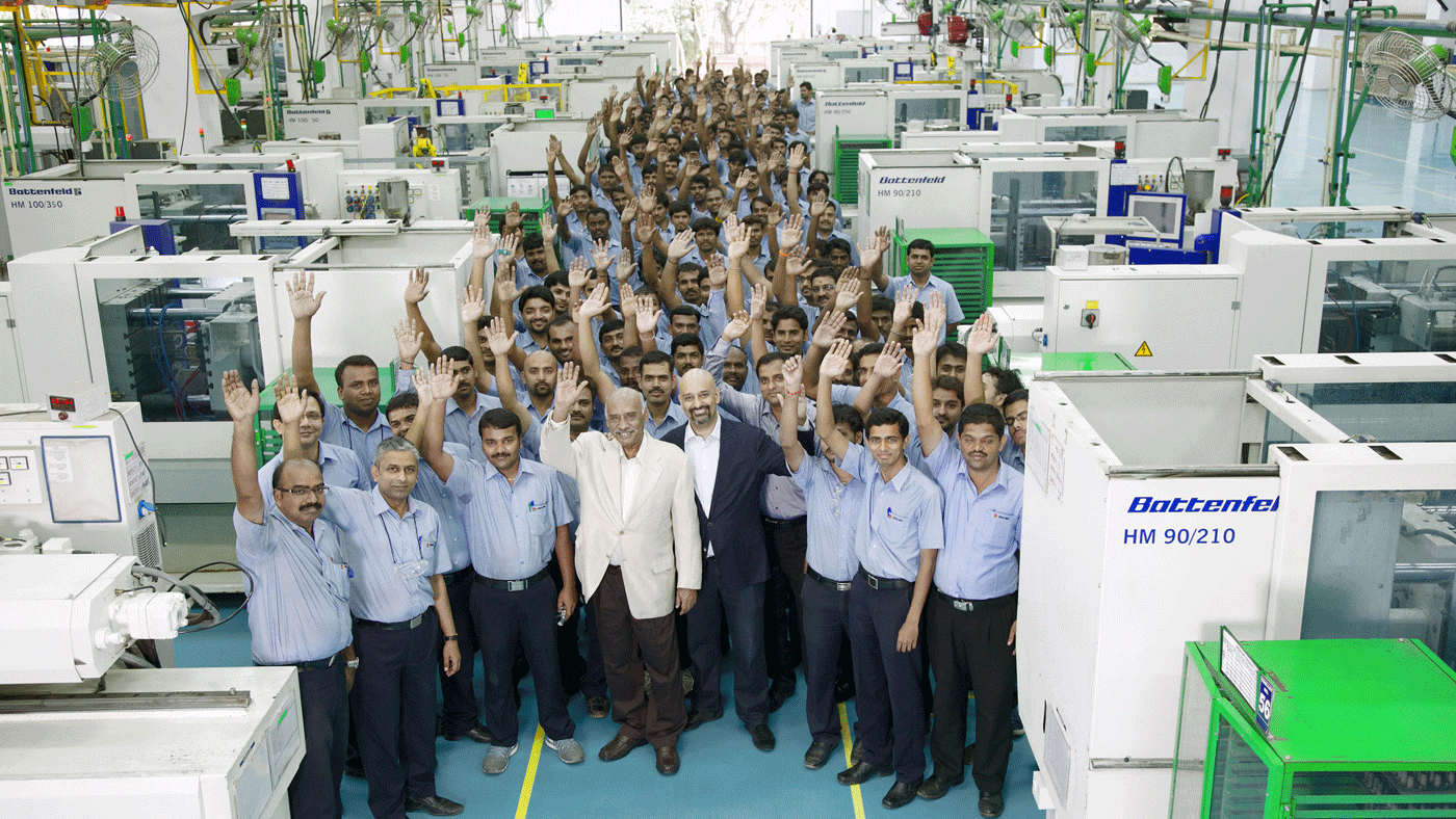 Indo-MIM employees in 2016 with Krishna Chivukula Sr. (centre left) and Krishna Chivukula Jr. (centre right) in an injection moulding hall at Indo-MIM. Courtesy Indo-MIM (Published in PIM International, Vol. 10 No. 1, March 2016)