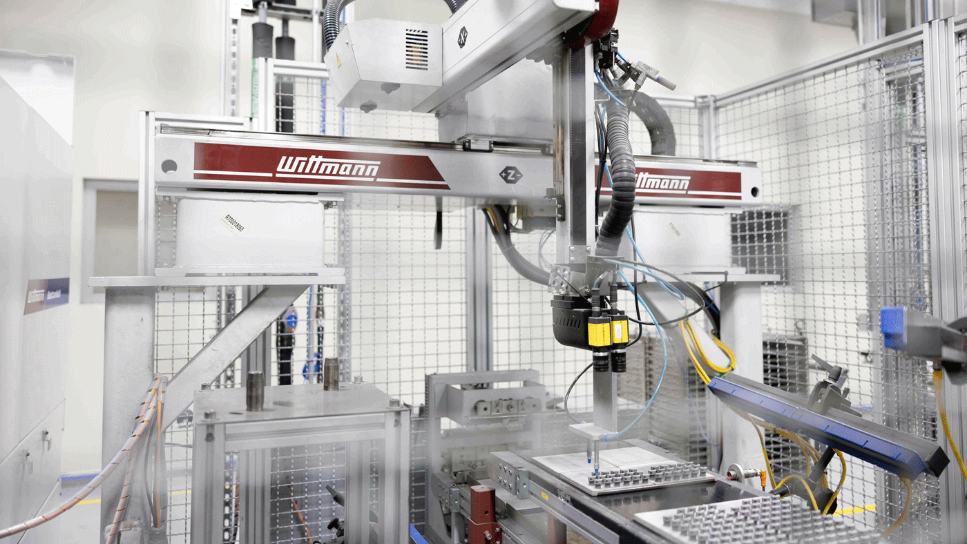 Fig. 9 The automated placement of green parts onto trays prior to debinding and sintering (Courtesy INDO-MIM)