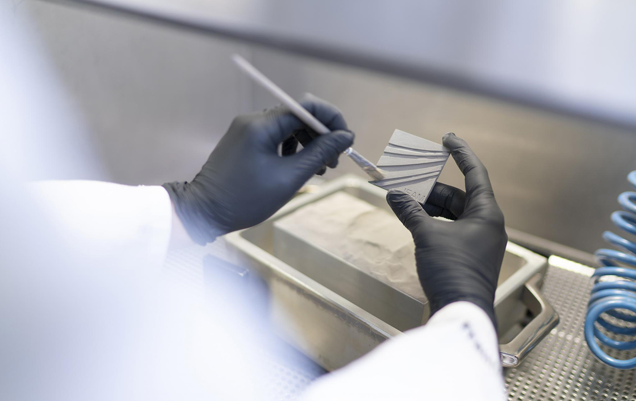 Removing the bottleneck: Automating depowdering for scalable Binder Jetting